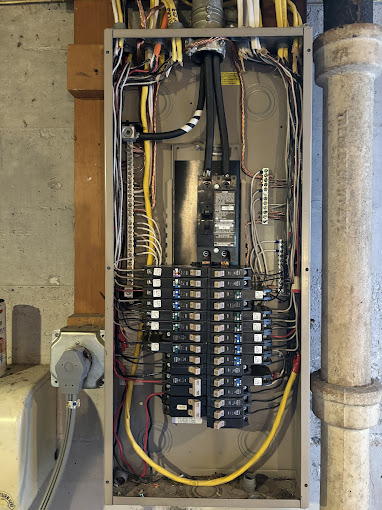 An electrical panel with multiple wires and wires in it